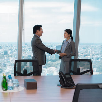 woman-and-man-shaking-hand-in-a-meeting-room.jpg