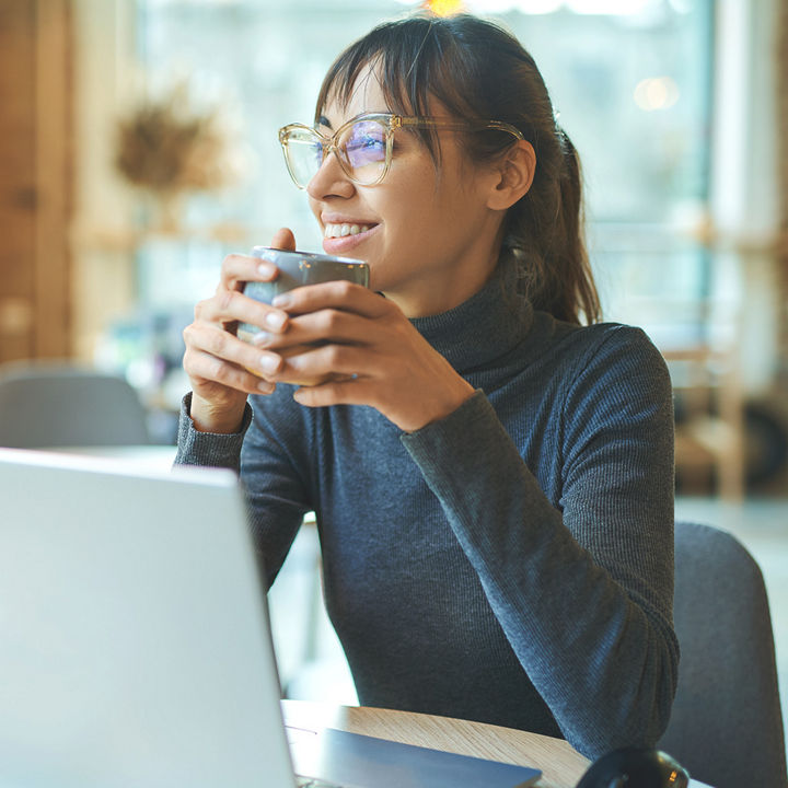 Woman at laptop with coffee