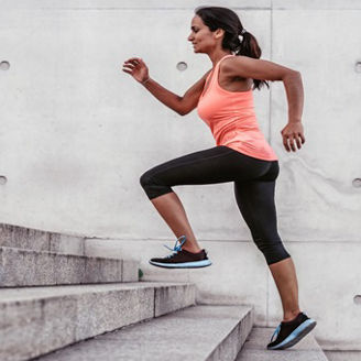 Woman helping a man climbing a mountain