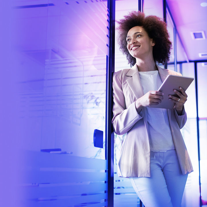 Woman holding a tablet in her hand and smiling