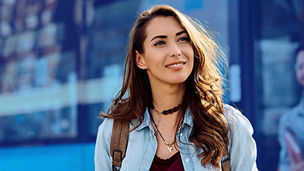 woman holding coffee and looking up