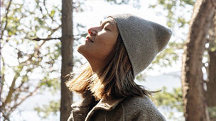 Woman in forest looking up