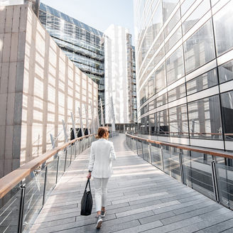 woman in white formals walking through office complex