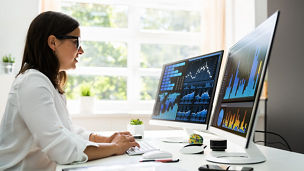 Analyst Women Looking At KPI Data On Computer Screen