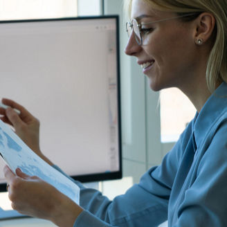Woman looking at sheets smiling