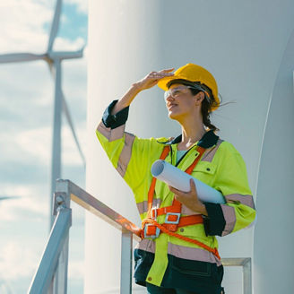 Woman looking at wind power plant