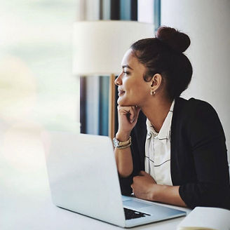 woman looking out of the window with laptop