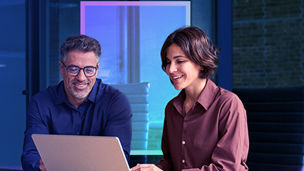 Two collegues working on laptop.