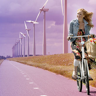 Woman on a bike with windmills in the background