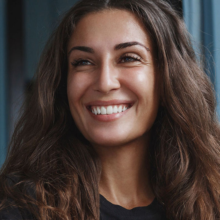 Woman on laptop smiling banner