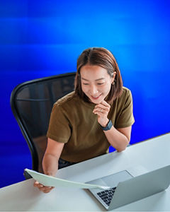 Woman working with paper and laptop
