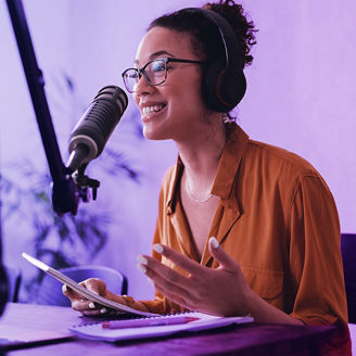Woman recording podcast with tablet in her hand