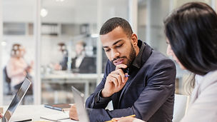 Woman showing notes to her colleague