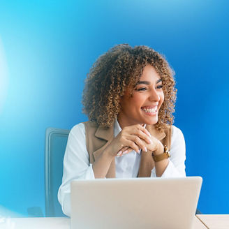 Woman sitting at meeting table with laptop and smiling