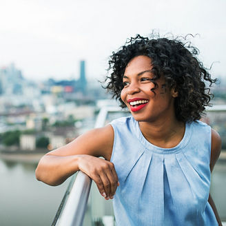 woman smiling alongside railing