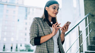 woman smiling and using mobilephone