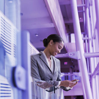 Woman in suit smiling at phone