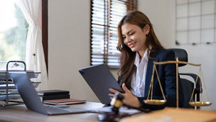 Woman smiling looking at tablet