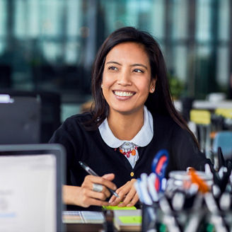 woman smiling while writing