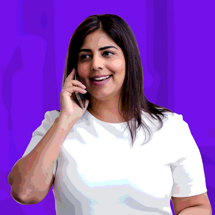 Woman in white talking on cell phone