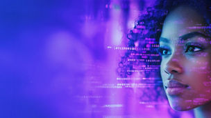 A close-up of a woman looking at a web-like pattern of computer code on a screen.