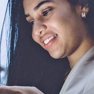 Woman using her phone and smiling