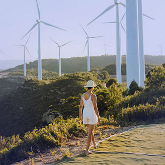 Woman walking near windmills banner