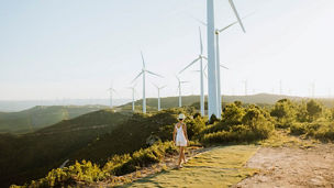 Woman walking near windmills