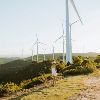 Woman walking near windmills