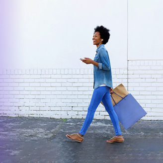 Woman walking white brick wall
