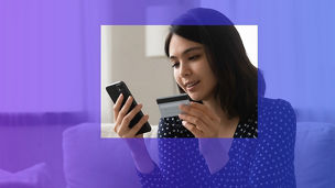 Woman with credit card laughing