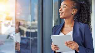 woman with curly hair looking outside window