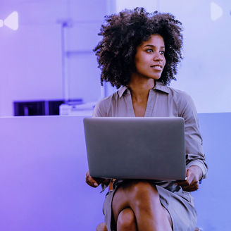 woman with curly hair using laptop