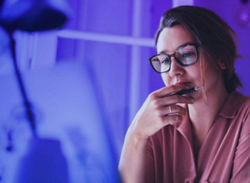 woman-with-glasses-holding-pen-banner