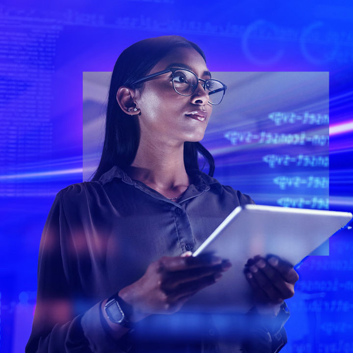 Woman with glasses looking at tablet and statistics