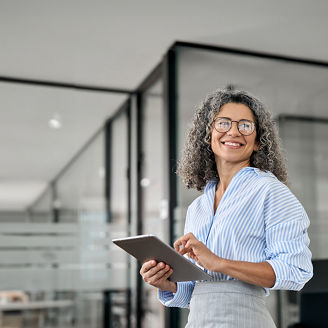 Woman with Glasses Smiling Sideways Holding Tablet