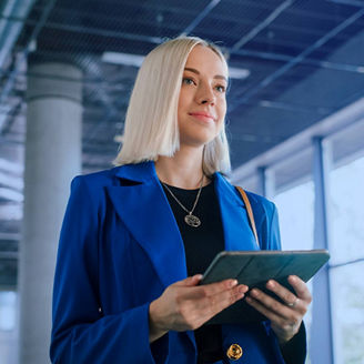 Portrait of smart afro young entrepreneur woman using her digital tablet while standing in the office