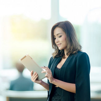 Beautiful asian businesswoman using tablet in office