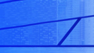 woman looking out of the window from a building with glass