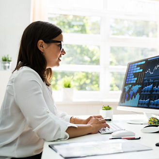 Analyst Women Looking At KPI Data On Computer Screen