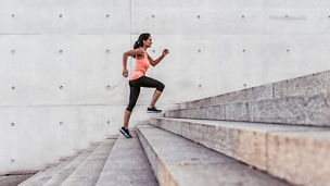 latina sports woman running up outdoor stairway in berlin