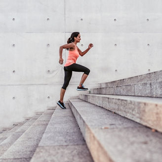 latina sports woman running up outdoor stairway in berlin