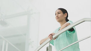 Women standing by holding railing