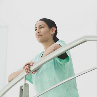 Women standing by holding railing