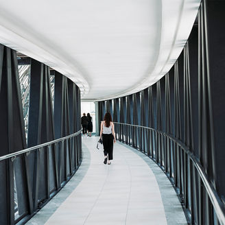 Women walking in corridor with black bars