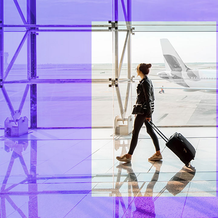 Women walking on airport with a bag