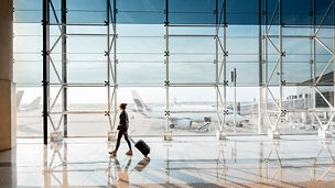 Women walking on airport with a bag