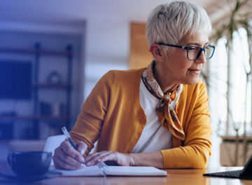 woman writing on ipad