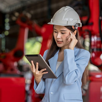 Worker wearing a cap and looking at tablet