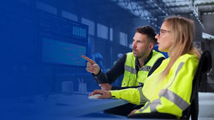 Workers in safety vests using computer